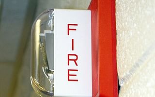 How often should fire alarm systems be inspected in commercial buildings?