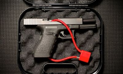 What is the safest way to store a handgun for home protection?